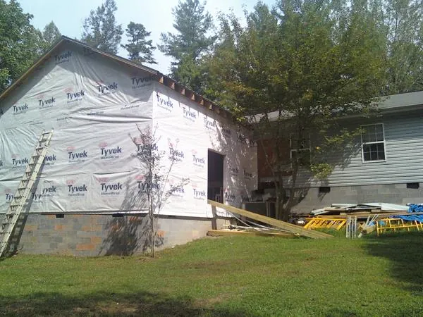 Tyvek wrapped gable on a new room addition beside an existing home in Kirkwood